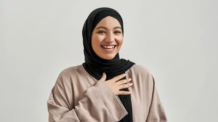 Foto op Plexiglas Portrait of laughing young arabic woman in hijab © Svitlana