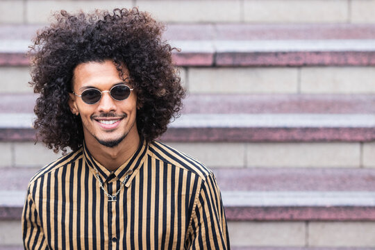 Handsome man wearing sunglasses in front of staircase