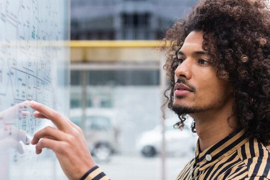 Young man checking directions on map