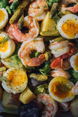 salad with shrimp, hard boiled eggs, pickles, fennel, purple potatoes, butter lettuce 