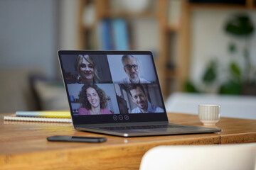 Business people on video conference through laptop over table