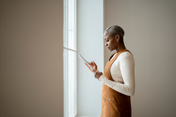 Woman using digital tablet at home