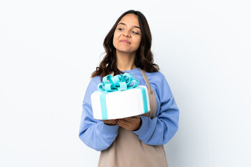 Pastry chef holding a big cake over isolated white background scheming something