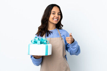 Pastry chef holding a big cake over isolated white background holding copyspace imaginary on the palm to insert an ad and with thumbs up