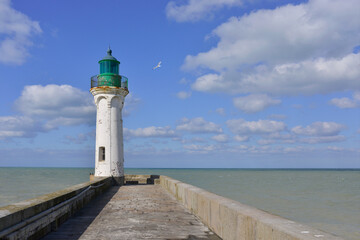 Fototapeta na wymiar Le phare de Saint-Valery-en-Caux (76460) en plein ciel bleu au bout de sa jetée, département de Seine-Maritime en région Normandie, France