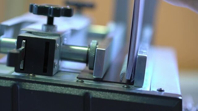 Paper binding machine mechanism in printing office