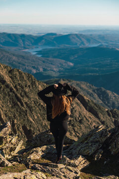 Woman wearing hat standing on mountain during vacations