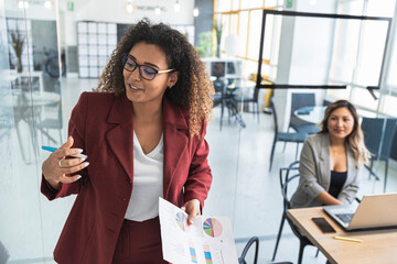 Female professional explaining financial report to colleague in office