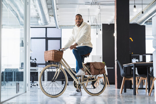Businessman on bicycle at coworking office