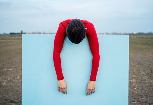 Woman leaning on blue painting