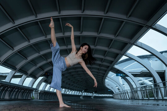 Female ballet dancer practicing on footbridge
