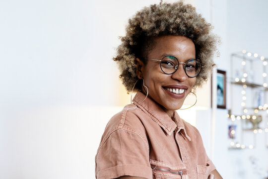 Businesswoman wearing heart shape earring at home office