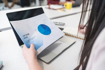 Businesswoman analyzing sales data in office