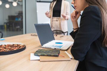 Businesswoman analyzing financial data over laptop at office