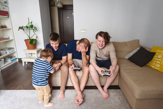Father with sons playing game at home