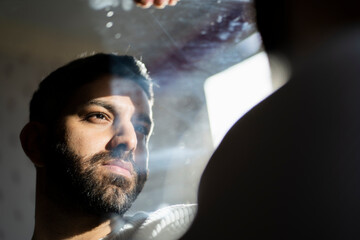 Man reflecting in mirror at home