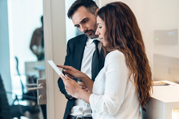 Businesswoman discussing with male professional in office
