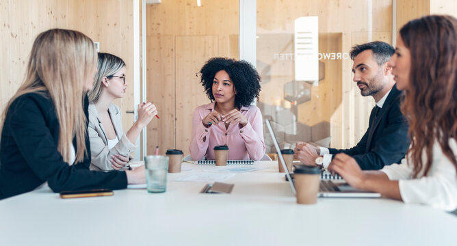 Multi-ethnic professionals planning business strategy in office