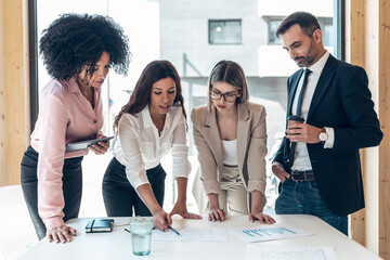 Multi-ethnic male and female business professionals planning in office