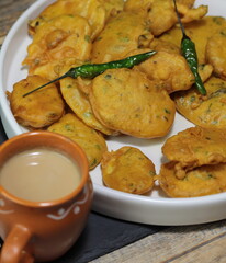 Vegan Aloo Pakora, Aloo Pakoda, Potato Fritters a thin slice of Potato dipped in Gram flour with spices and deep fried.