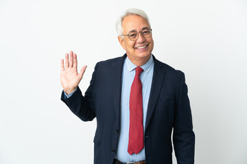 Middle age Brazilian business man isolated on white background saluting with hand with happy expression