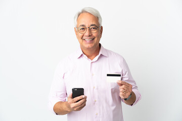 Middle age Brazilian man isolated on white background buying with the mobile with a credit card