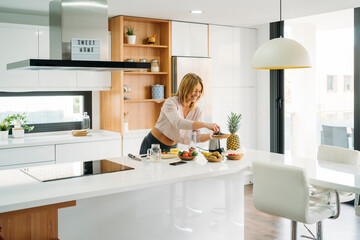 Caucasian woman preparing breakfast in kitchen at home