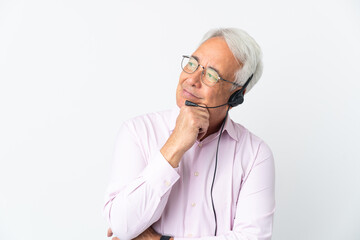 Telemarketer Middle age man working with a headset isolated on white background having doubts