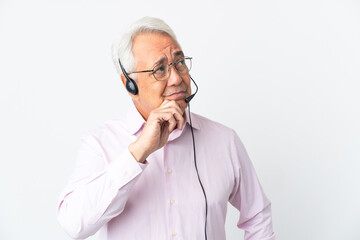 Telemarketer Middle age man working with a headset isolated on white background having doubts and thinking