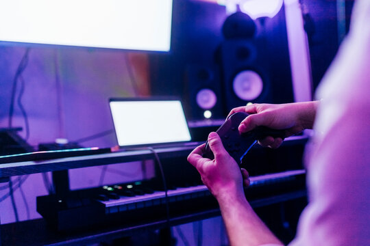 Man playing video game with controller at home