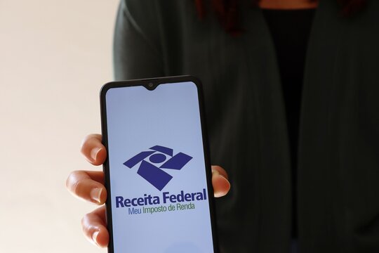 Receita Federal Meu Imposto de Renda logo on smartphone screen. IRPF. Receita Federal (RFB) is the Brazilian federal revenue service agency. 