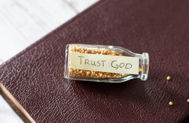 Mustard seed faith. Trust in God Jesus Christ. Bottle with handwritten Bible text and mustard...