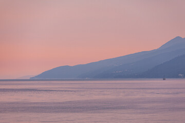 sunset above sea bay. seaside with mountains
