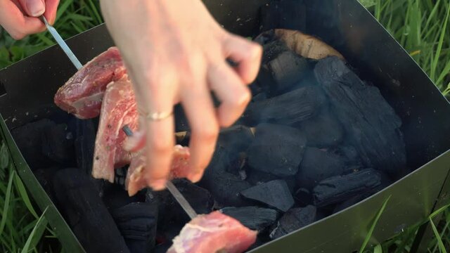 Close-up of cooking a delicious grilled dish on the barbecue. The process of cooking a delicious barbecue in nature. It's time for a picnic. Street food. Food festival. Pork on the fire