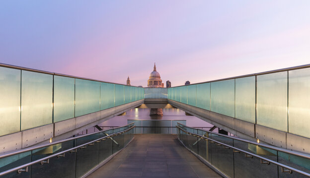UK, England, London, Diminishing perspective of Millennium Bridge at dawn with Saint Pauls Cathedral in background