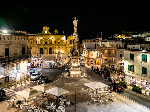 Italy, Province of Brindisi, Ostuni, Column of&nbsp;Saint&nbsp;Orontius standing in middle of illuminated town square at night