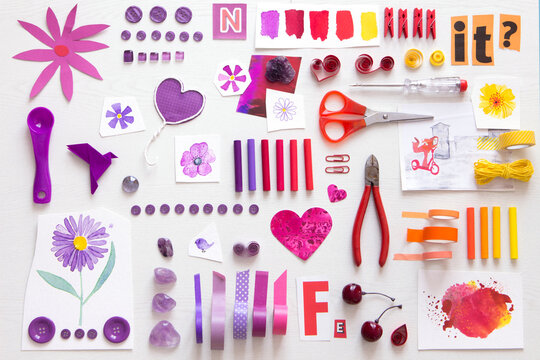 Arrangement of various tools and sewing items going from purple to red and yellow