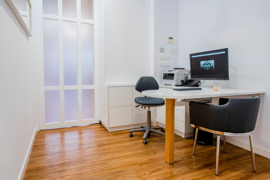 Empty chairs and computer at dentist's clinic