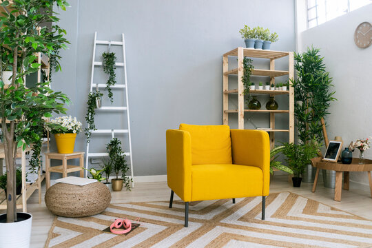 Empty Yellow Couch Amidst Plants In Modern Home