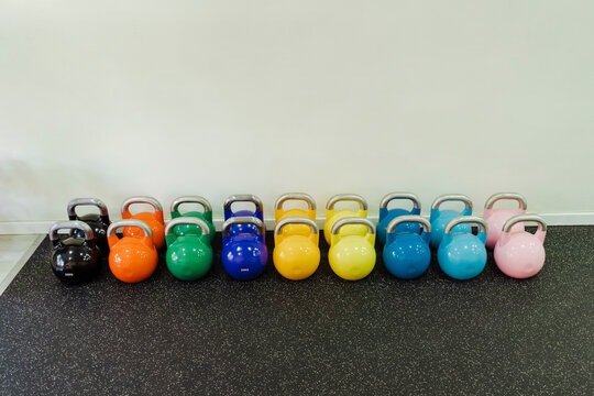 Arrangement of multi colored kettlebells in health club