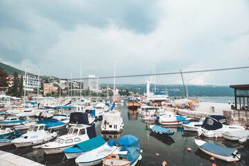 Fototapeta na wymiar Opatija, Croatia - June 4, 2019: view of city harbor with boats ships and yachts