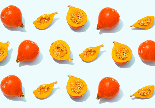 Pattern of rows of whole and halved red kuri squashes
