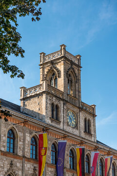 Germany, Thuringia, Weimar, Town hall with clock, carillon and flags