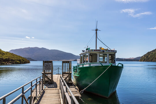 Fishboat moored by wooden pier
