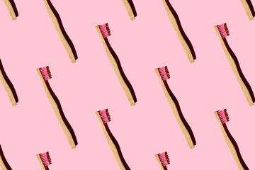 Digitally generated pattern with bamboo toothbrushes on pink background