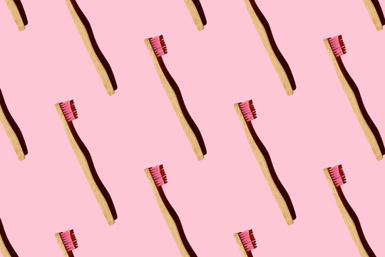 Digitally generated pattern with bamboo toothbrushes on pink background