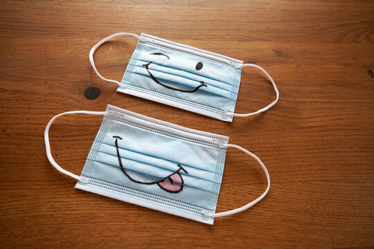 Face masks with smiley drawing on wood