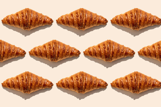 Crunchy butter croissants placed on beige background