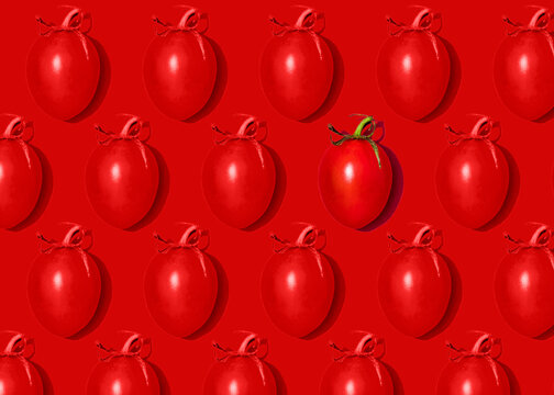 Pattern of rows of cherry tomatoes flat laid against red background