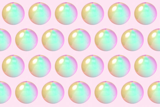 Three dimensional pattern of rows of bubbles against pink background